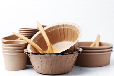 Photo of Set of disposable tableware on white table, closeup