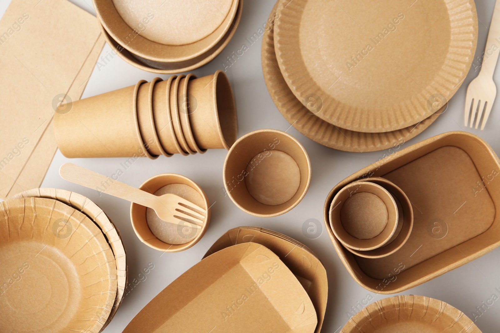 Set of disposable tableware on white background, flat lay Photo of Set of disposable tableware on white background, flat lay