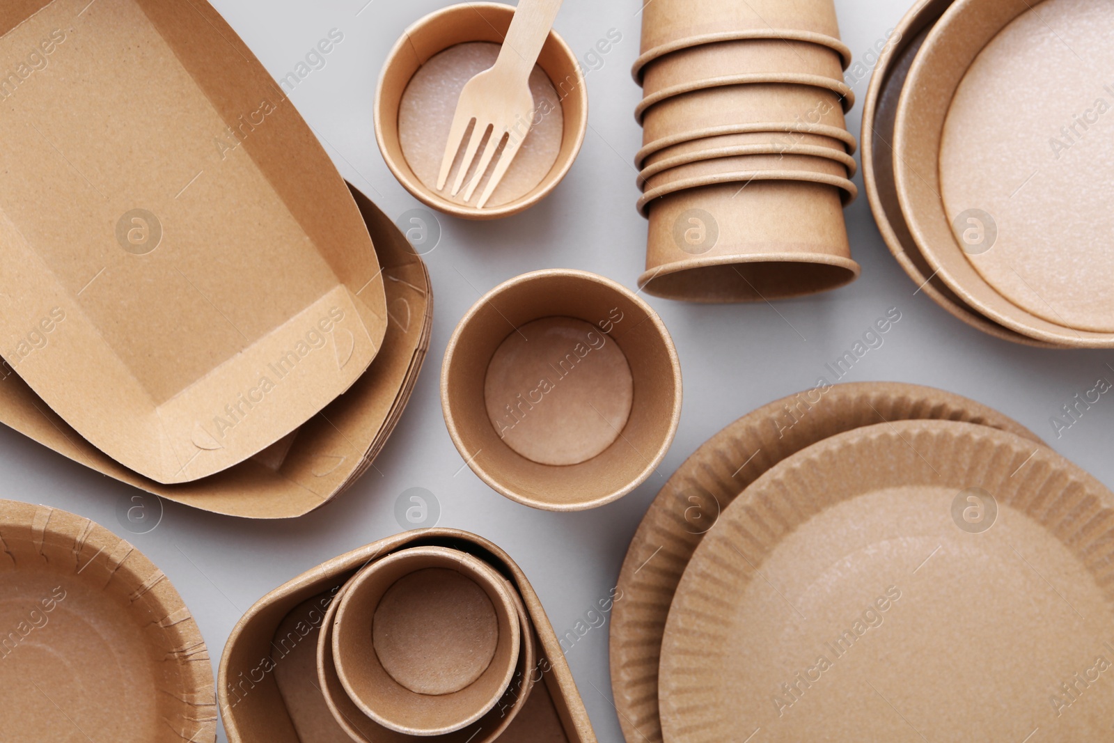 Set of disposable tableware on white background, flat lay Photo of Set of disposable tableware on white background, flat lay