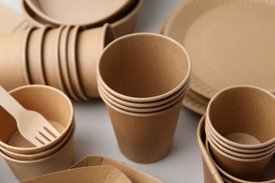 Photo of Set of disposable tableware on white background, closeup