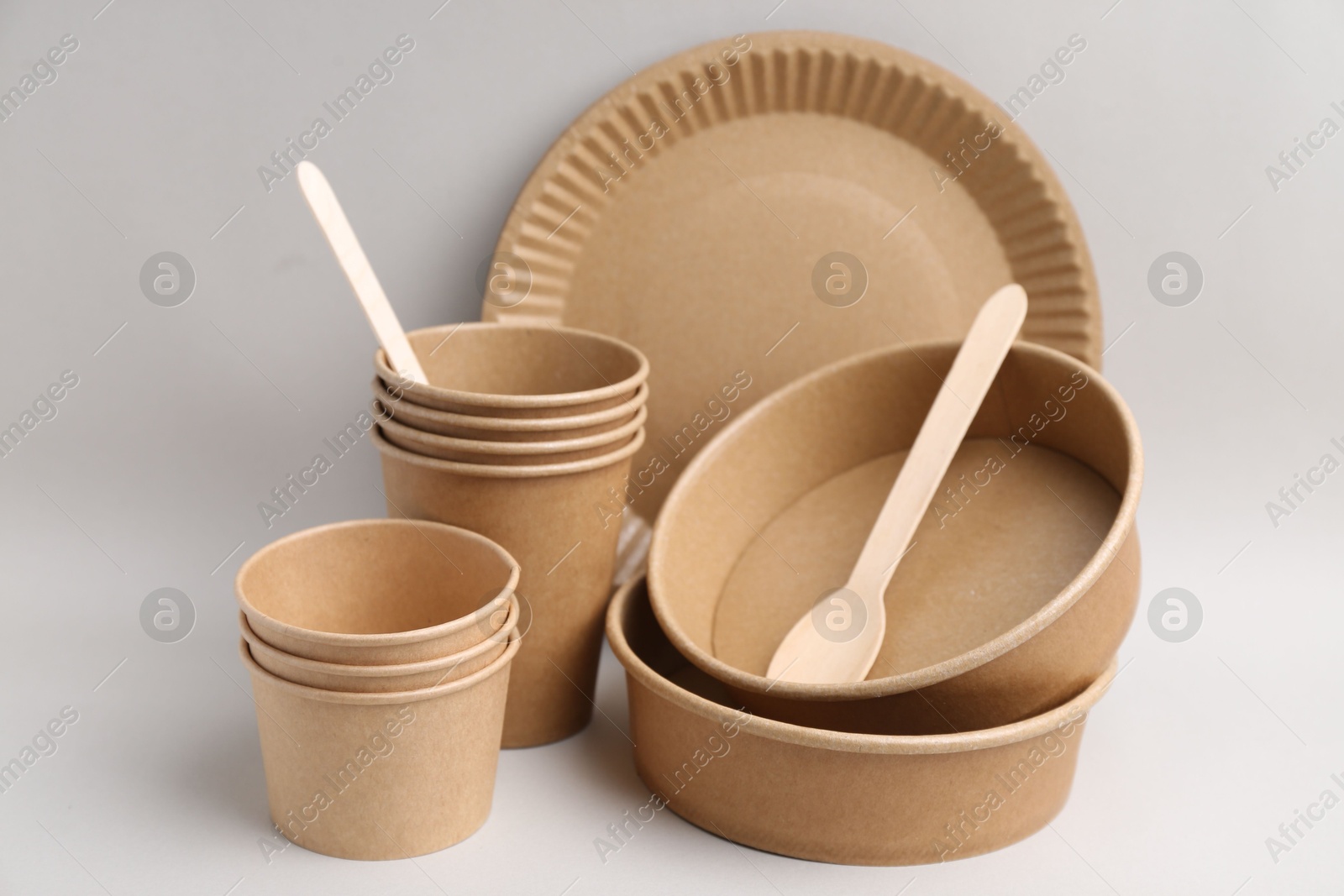 Set of disposable tableware on light grey background, closeup Photo of Set of disposable tableware on light grey background, closeup