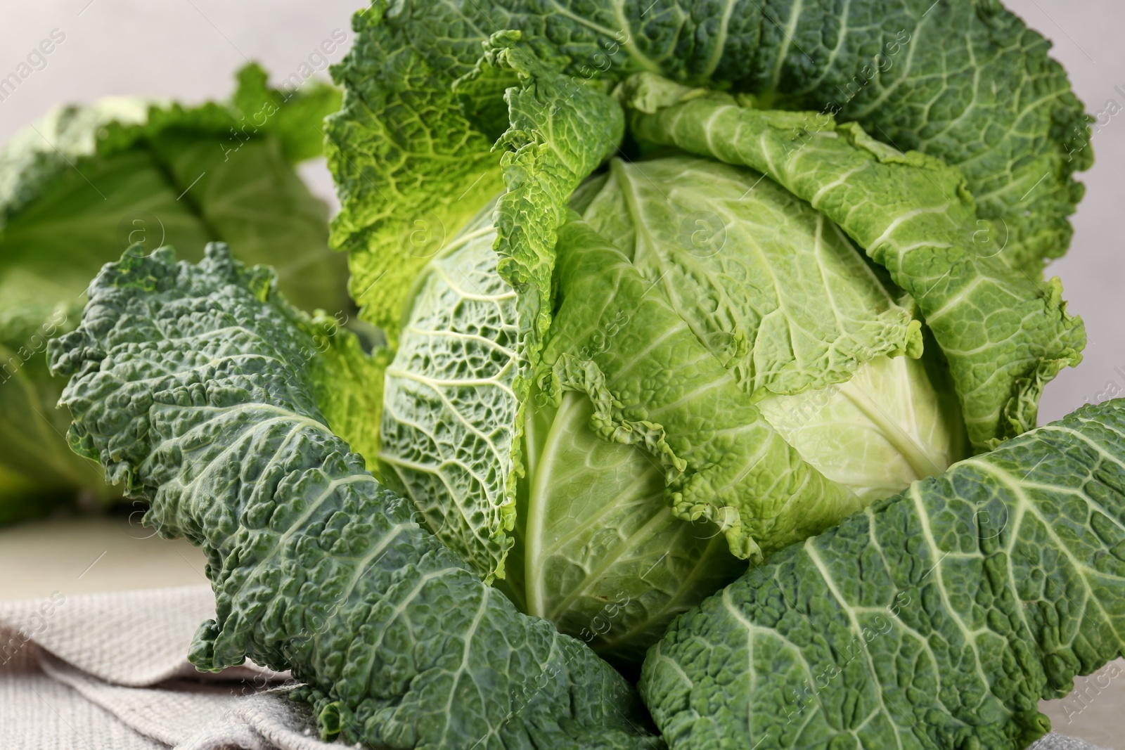 Photo of Fresh ripe Savoy cabbages on table, closeup