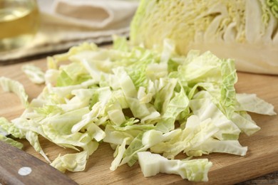 Photo of Shredded Savoy cabbage on wooden board, closeup