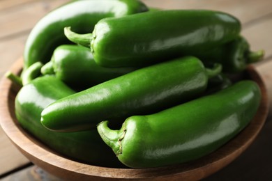 Photo of Fresh jalapeno peppers in bowl on table, closeup
