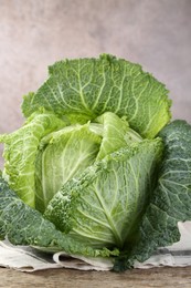 Photo of Fresh ripe Savoy cabbage on wooden table, closeup