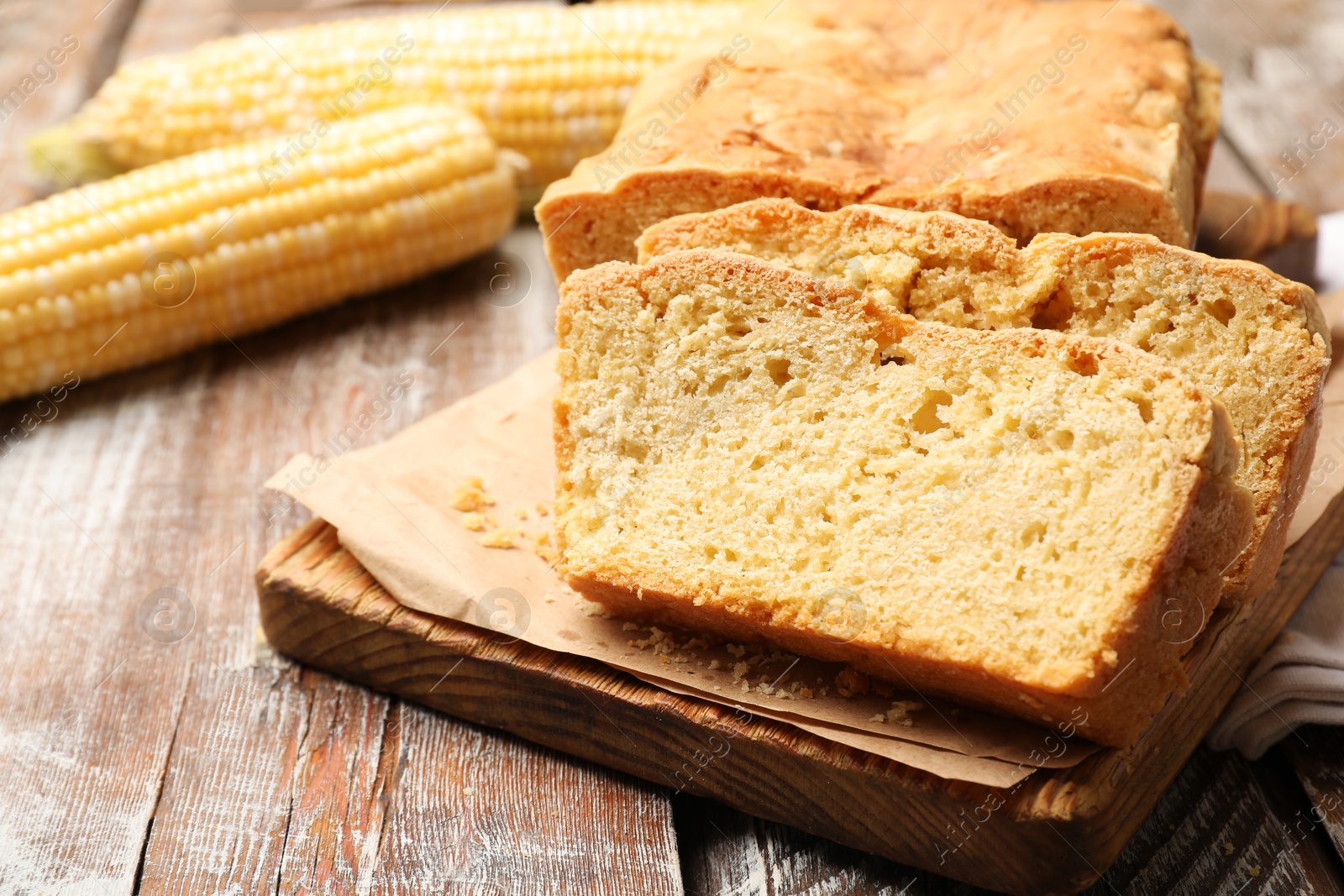 Freshly baked cut cornbread on wooden table, closeup Photo of Freshly baked cut cornbread on wooden table, closeup