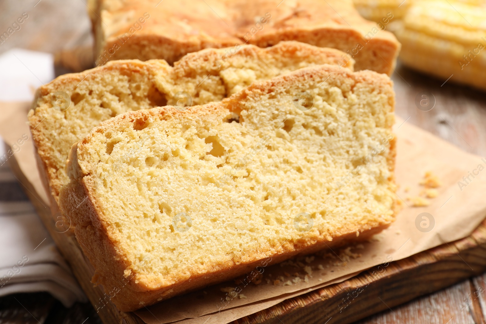 Freshly baked cut cornbread on wooden table, closeup Photo of Freshly baked cut cornbread on wooden table, closeup