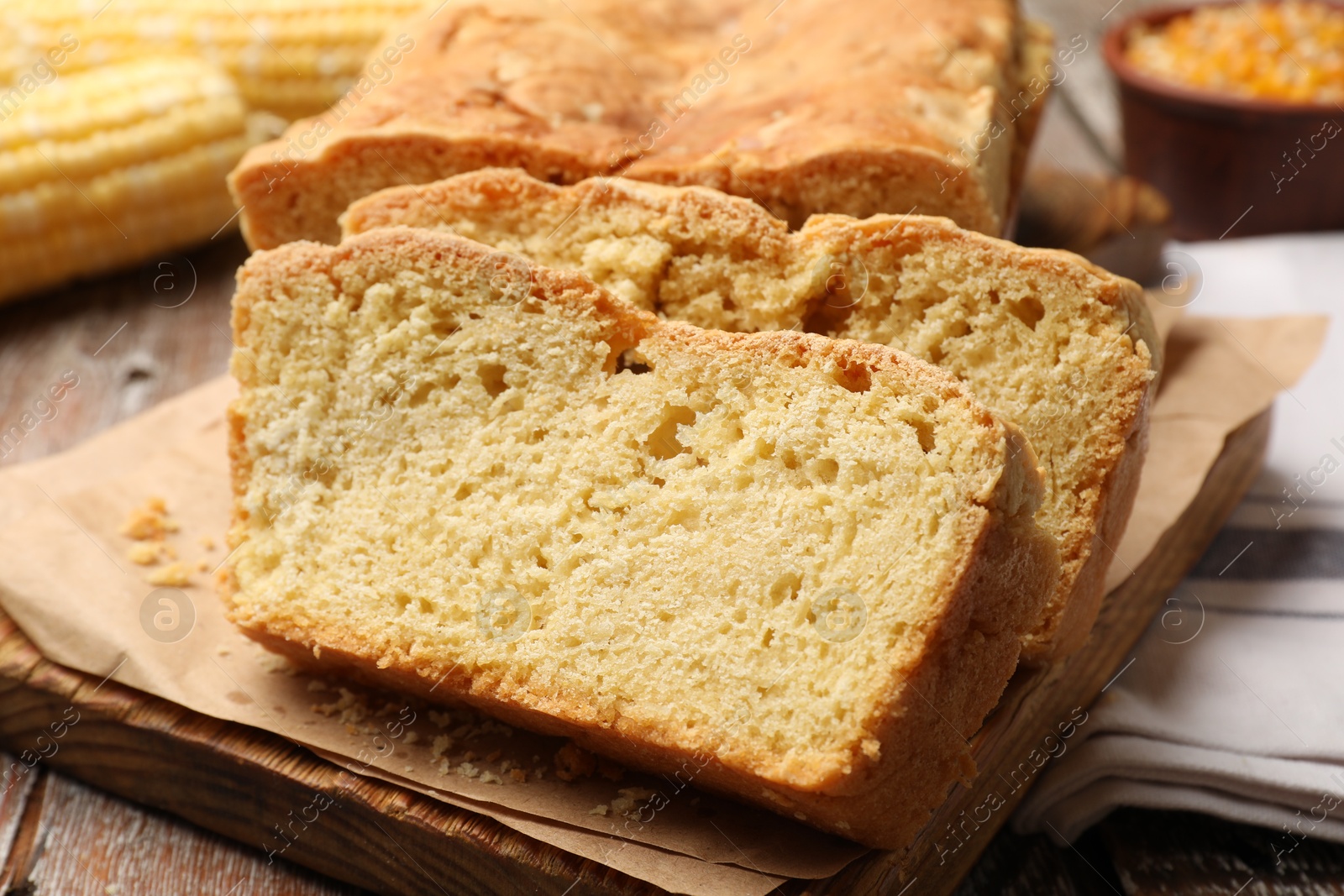Freshly baked cut cornbread on wooden table, closeup Photo of Freshly baked cut cornbread on wooden table, closeup