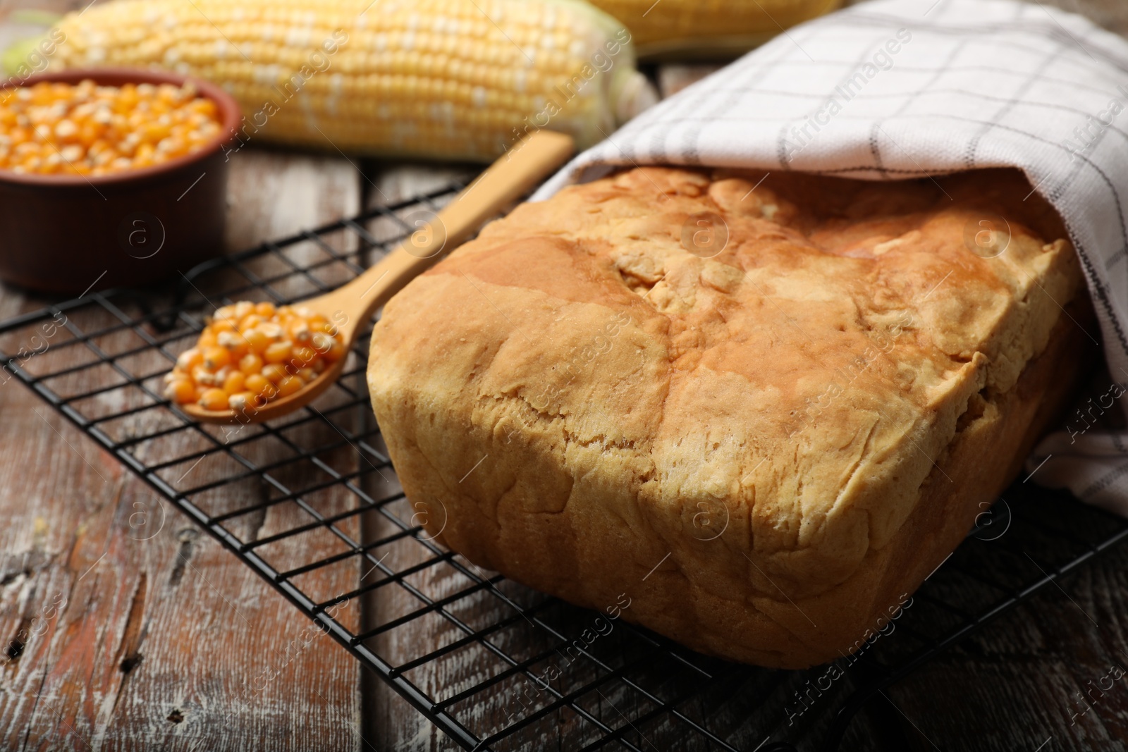 Freshly baked cornbread and seeds on wooden table, closeup Photo of Freshly baked cornbread and seeds on wooden table, closeup