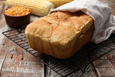Photo of Freshly baked cornbread and seeds on wooden table, closeup