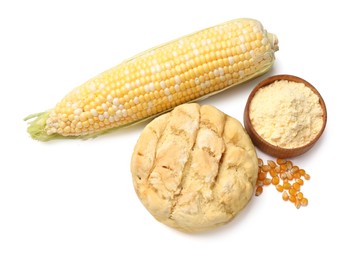 Photo of Freshly baked cornbread loaf, flour, cob and seeds isolated on white, top view