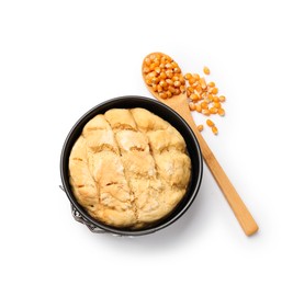 Photo of Freshly baked cornbread loaf and seeds isolated on white, top view