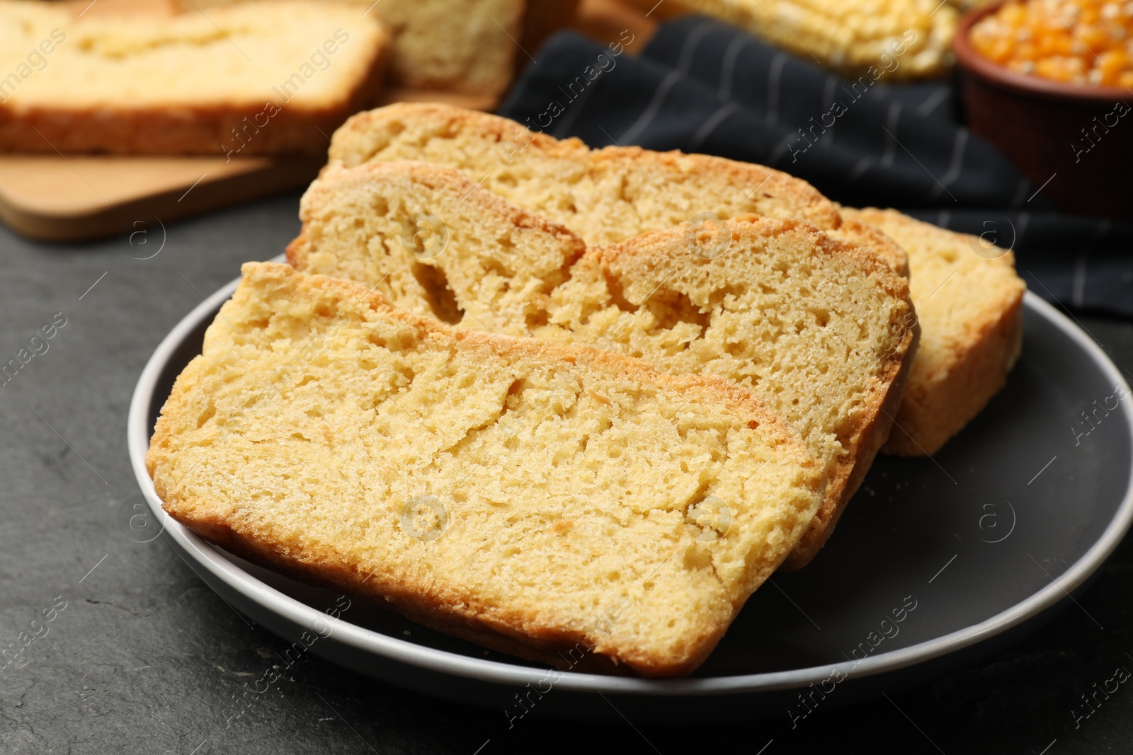 Pieces of freshly baked cornbread on black table, closeup Photo of Pieces of freshly baked cornbread on black table, closeup