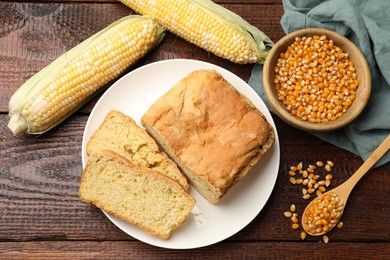 Photo of Freshly baked cornbread, cobs and seeds on wooden table, flat lay