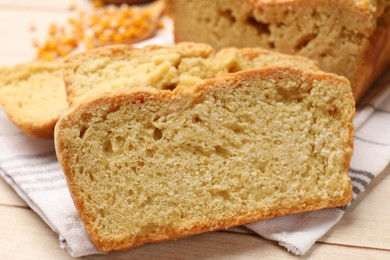 Photo of Freshly baked cornbread and seeds on wooden table, closeup