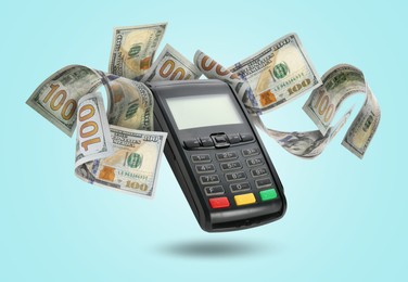 Image of Payment terminal and dollars in air on light blue background