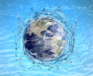 Image of Save water concept. Earth surrounded by splashing water against sea surface