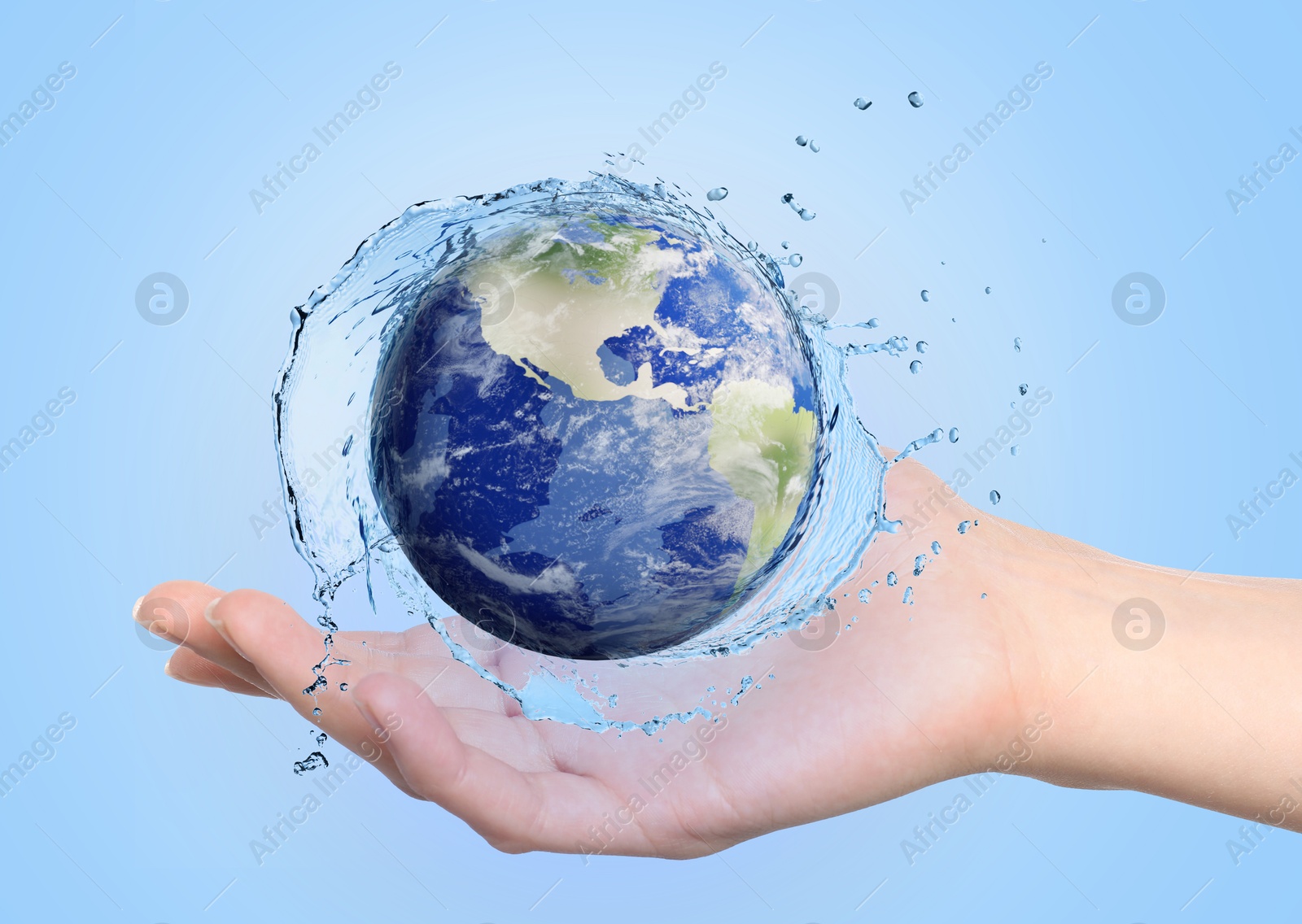 Save water concept. Earth surrounded by splashing water in woman's hand against pale blue background Image of Save water concept. Earth surrounded by splashing water in woman's hand against pale blue background