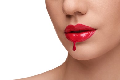 Image of Red liquid lipstick dripping from woman's lip against white background, closeup