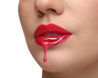 Image of Red liquid lipstick dripping from woman's lip against white background, closeup