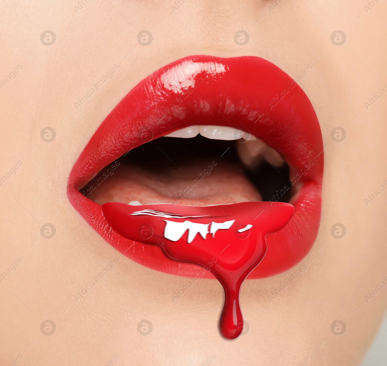 Image of Red liquid lipstick dripping from woman's lip, closeup