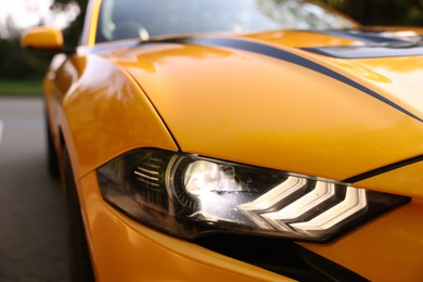 Photo of Modern cabriolet parked on parking lot outdoors, closeup