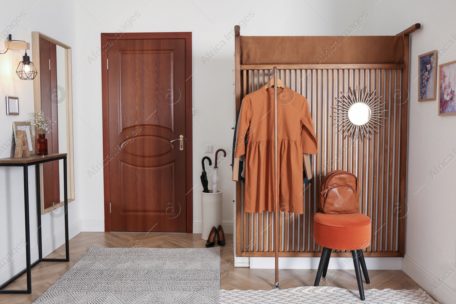 Photo of Modern hallway interior with stylish furniture and clothes rack