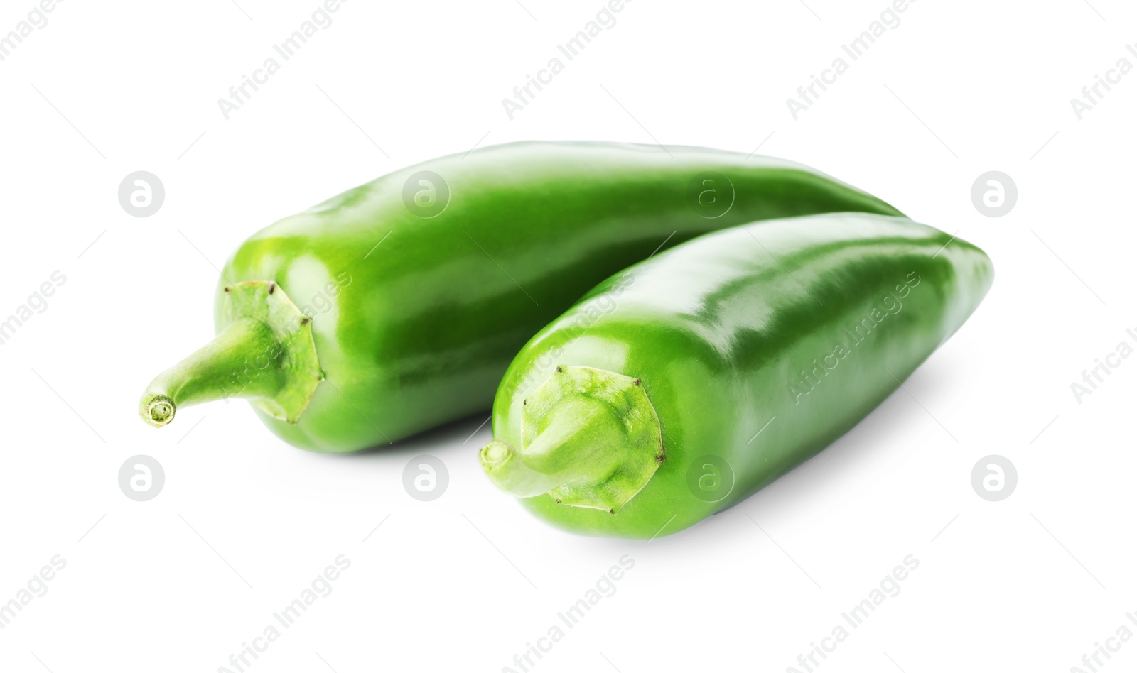 Photo of Two green jalapeno peppers isolated on white