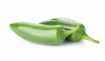 Photo of Two green jalapeno peppers isolated on white
