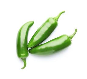 Photo of Many green jalapeno peppers isolated on white, top view