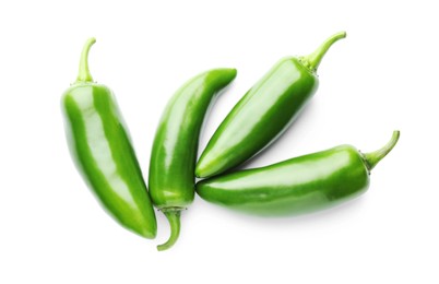 Photo of Many green jalapeno peppers isolated on white, top view