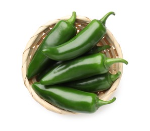 Photo of Green jalapeno peppers in basket isolated on white, top view