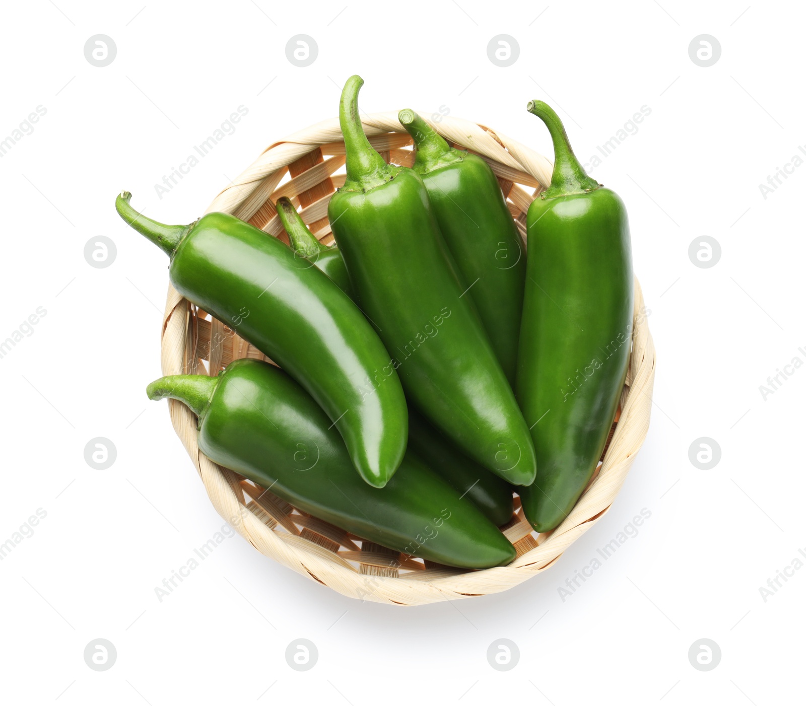 Photo of Green jalapeno peppers in basket isolated on white, top view
