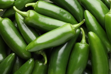 Photo of Many green jalapeno peppers as background, closeup