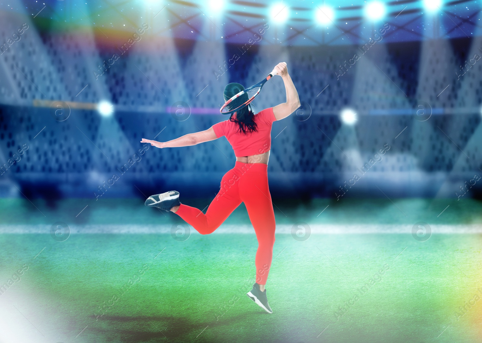 Image of Woman in red sportswear playing tennis at stadium