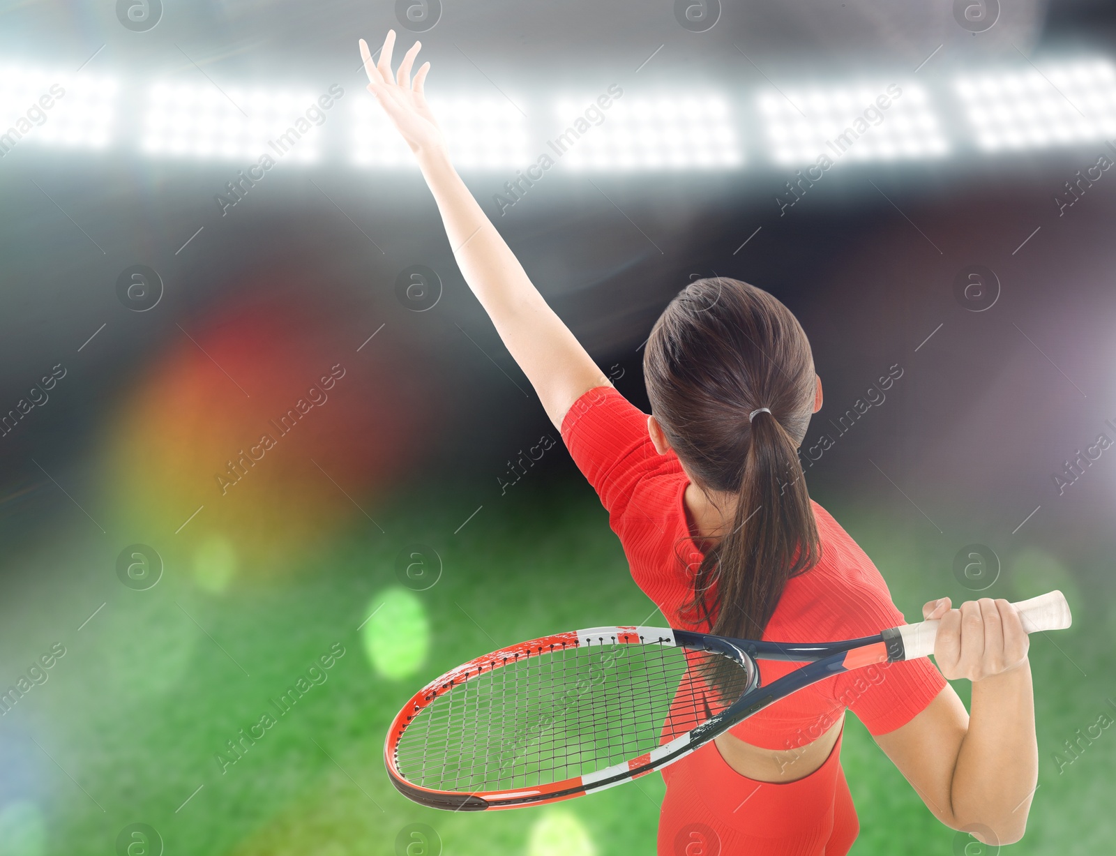 Image of Woman in red sportswear playing tennis at stadium