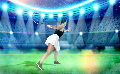 Image of Woman with racket playing tennis at illuminated stadium