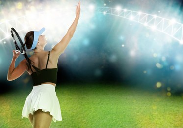 Image of Woman with racket playing tennis at illuminated stadium