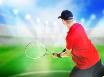 Image of Man with racket playing tennis at stadium
