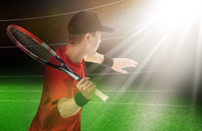 Image of Man with racket playing tennis at stadium