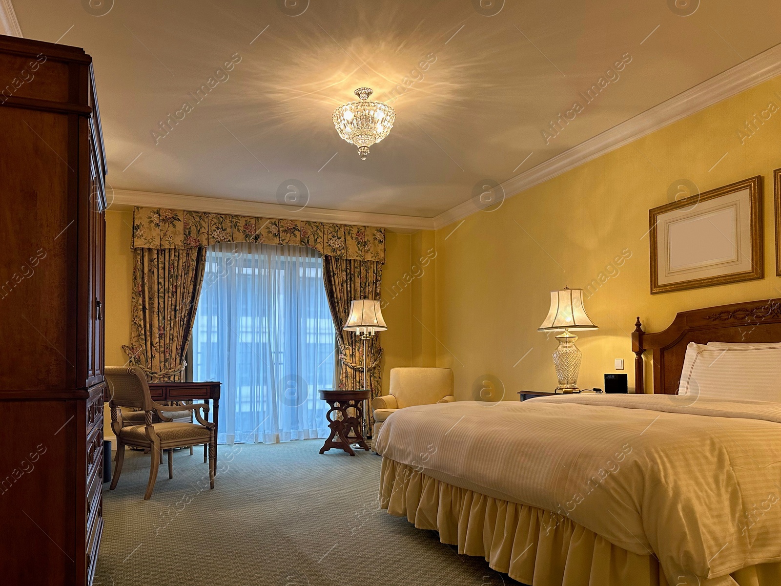 Photo of Luxury hotel interior. Comfortable large bed and modern furniture in stylish room