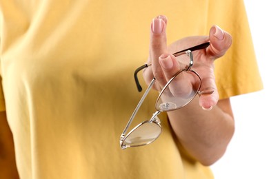 Photo of Woman choosing between glasses and contact lens on white background, closeup