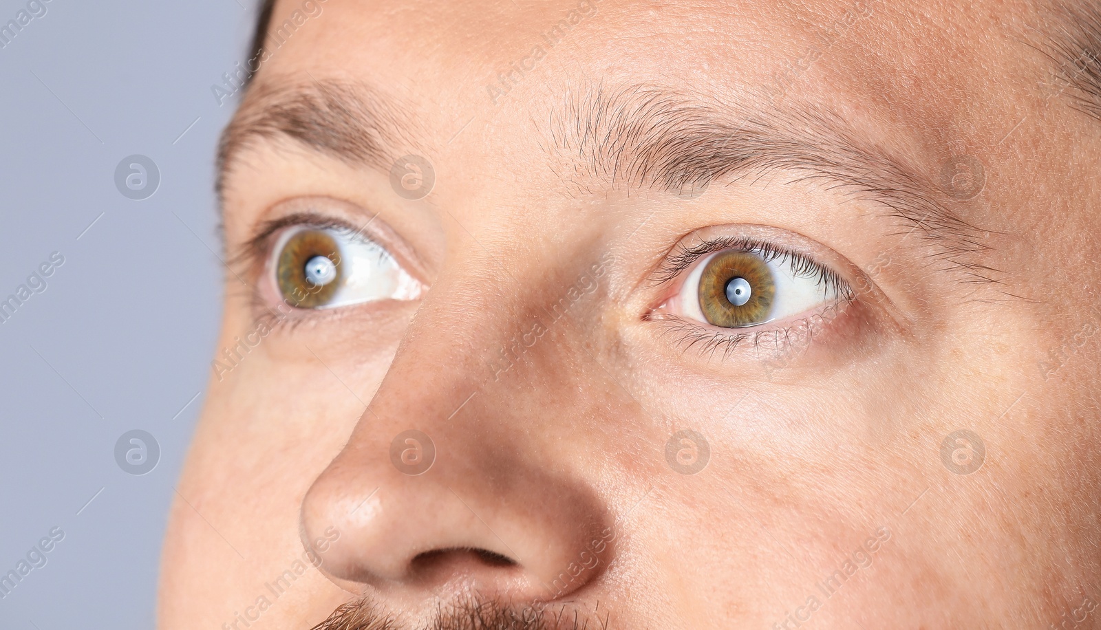 Photo of Man with beautiful eyes on light grey background, closeup