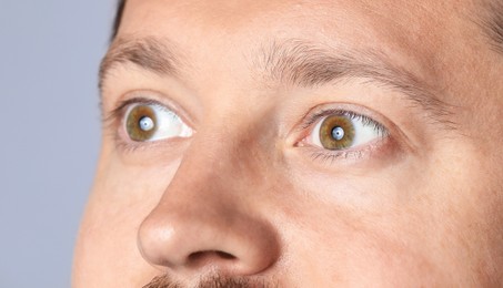 Photo of Man with beautiful eyes on light grey background, closeup