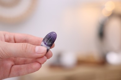 Photo of Woman with beautiful gemstone on indoors, closeup. Space for text
