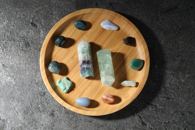 Photo of Different beautiful gemstones on grey table, top view