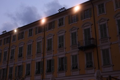Photo of Beautiful building with windows in city at evening, low angle view