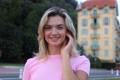 Photo of Portrait of happy young woman in city