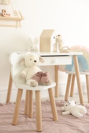 Photo of Different cute toys, baby shoes and furniture in child's room