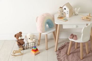 Photo of Different cute toys and furniture in child's room